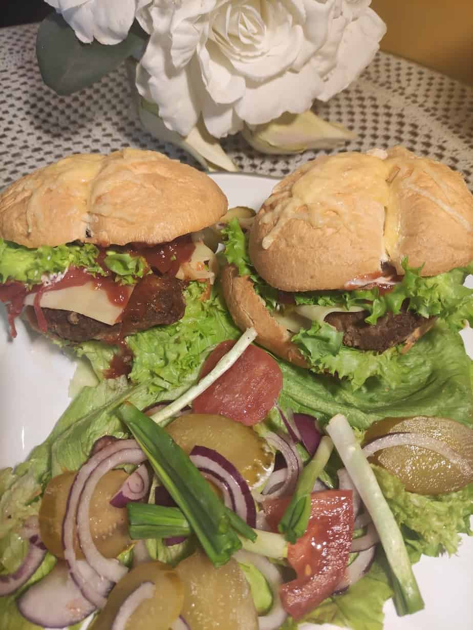 Polish burgers on a white plate.