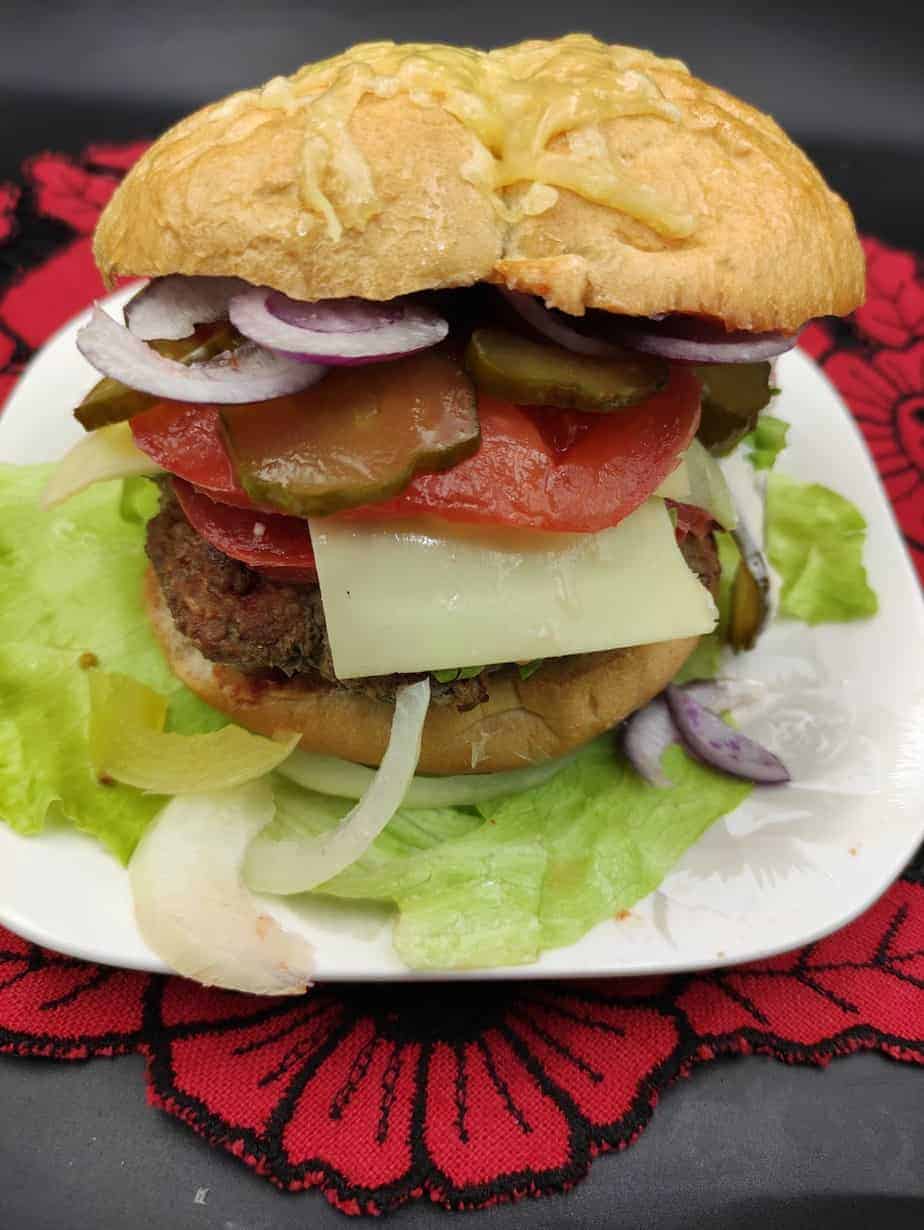 Polish beef hamburger on a white plate.