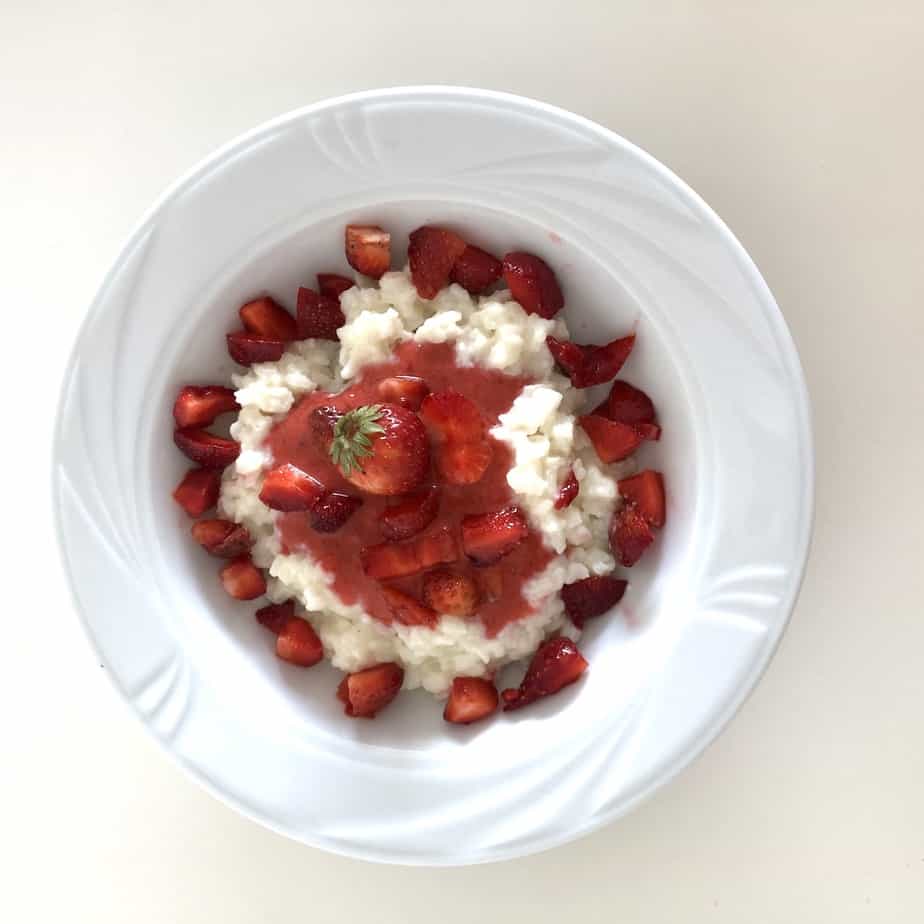 Polish Rice Pudding With Strawberries in a white bowl.