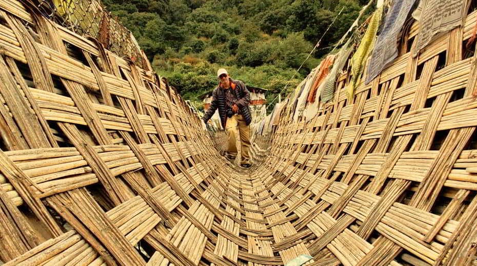 Chakzam bridge ancient engineering marvel in Tawang arunachal pradesh. The bridge is stayed using iron chains and covered by mat made of bamboo and cane. Initially vasu struggled to walk