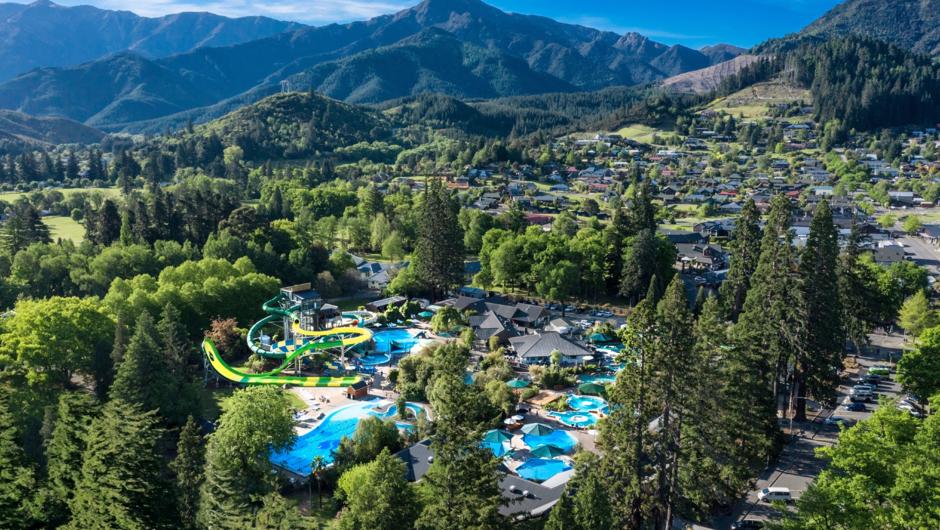 Aerial view of a scenic New Zealand South Island water park with lush green mountains