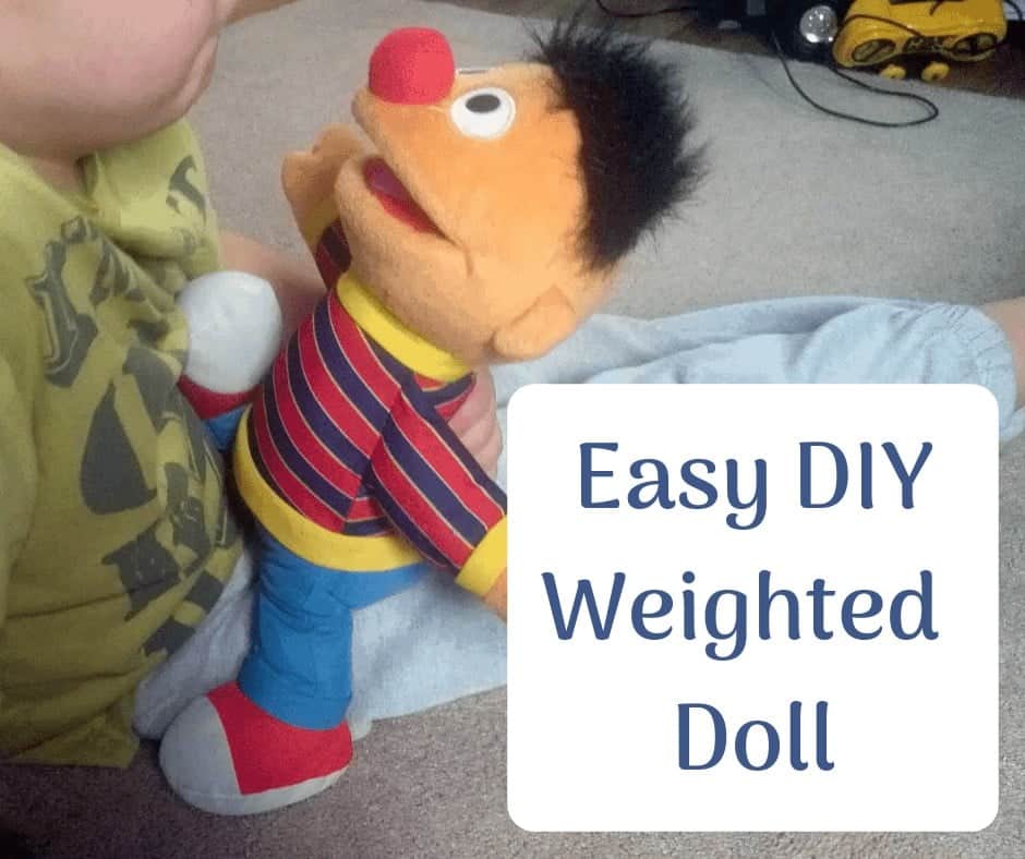 Little boy with an Ernie DIY weighted doll on his lap.