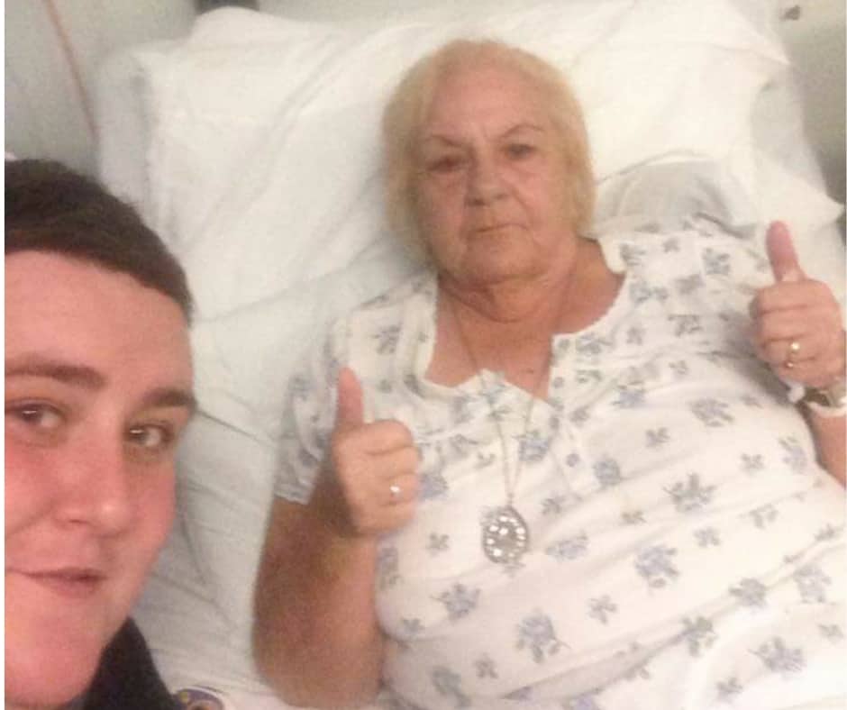 A man and a woman taking a selfie in bed