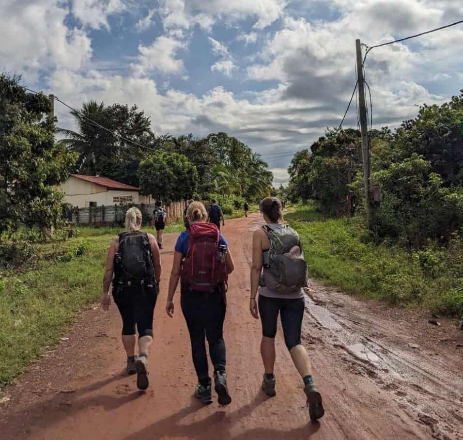 Trekkers exploring rural jungle landscapes around Angkor Wat, walking through forest trails, countryside paths, and hidden temple areas in Cambodia’s backcountry.