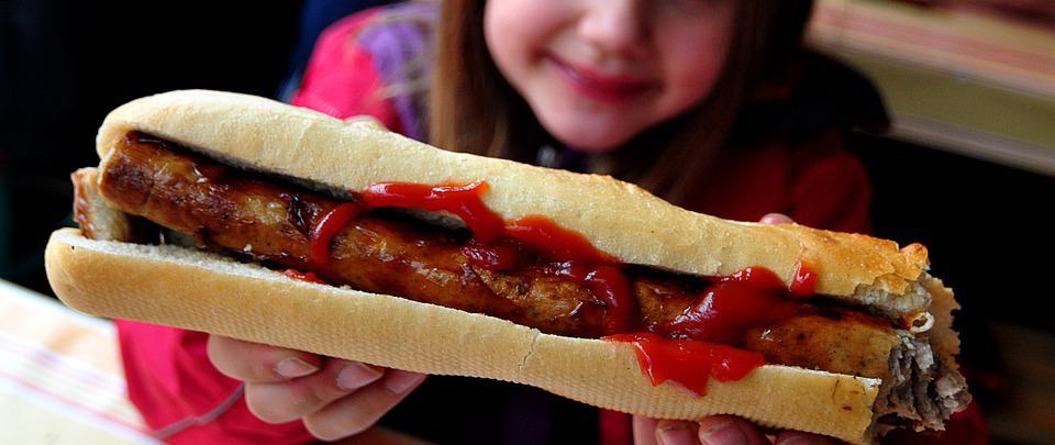 Child holding hot dog.