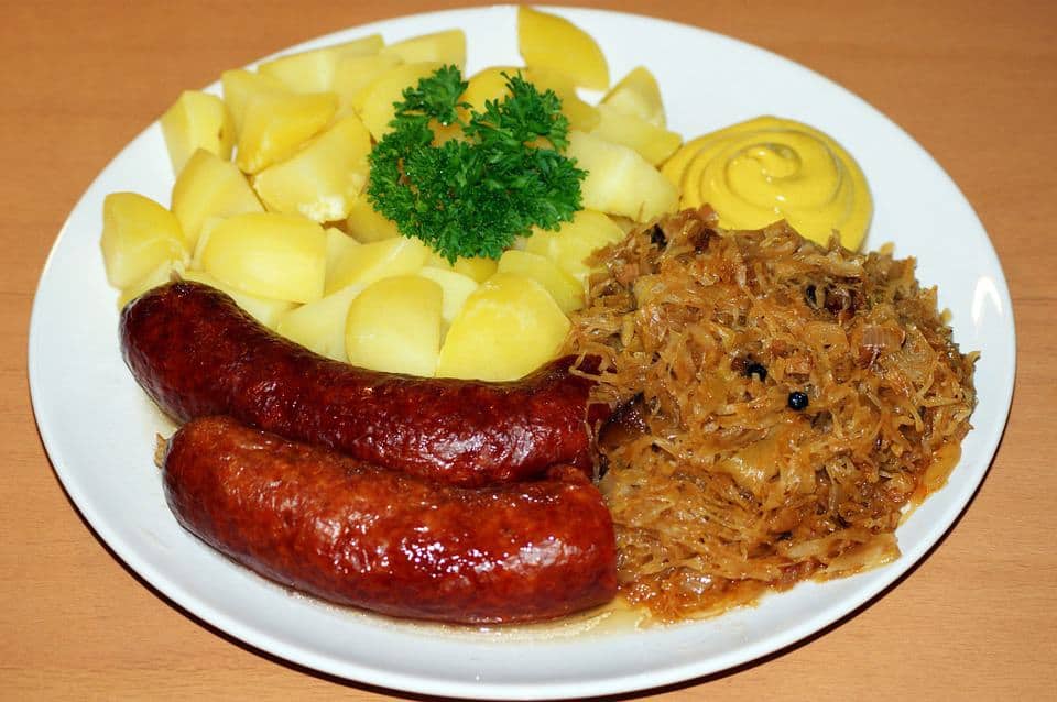 Kielbasa sausages with boiled potato and sauerkraut.