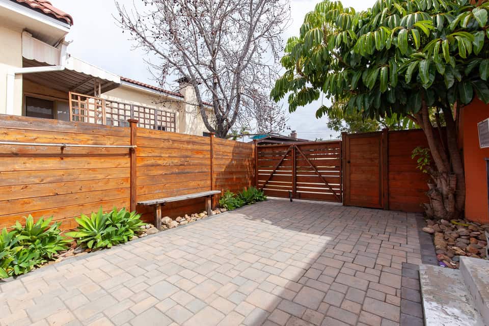 3530 Park Villa Drive - Entry Way with Stained Wooden Fences, A Bench, and Some Greenery