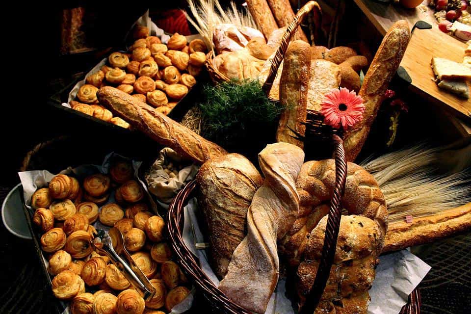 Breads in different baskets and plates.