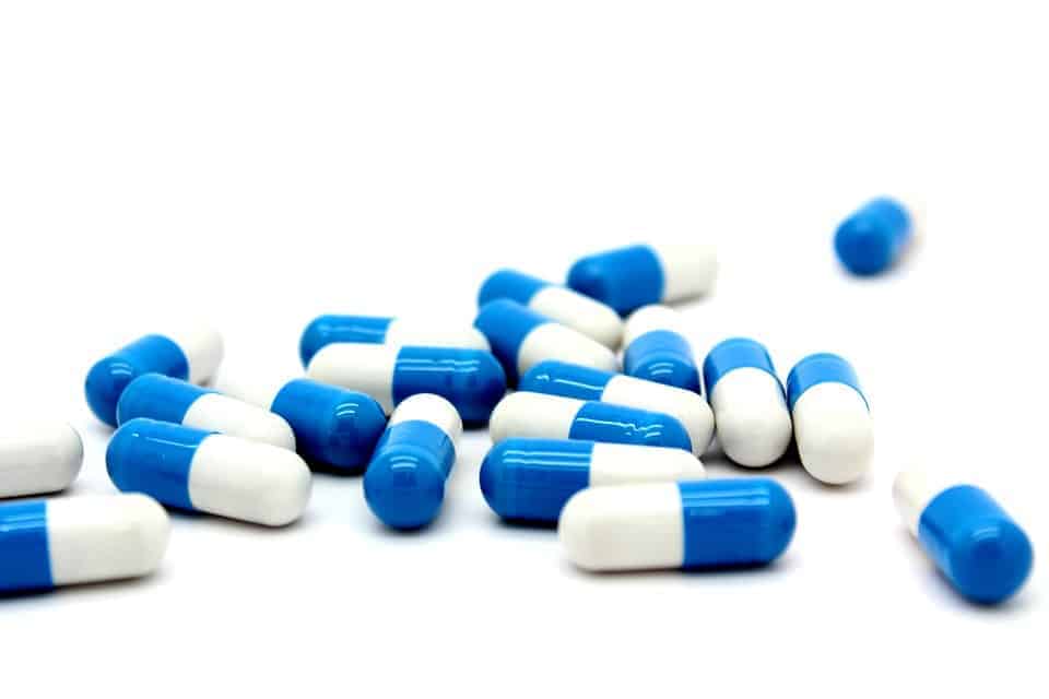 Close up of blue and white pill capsules
