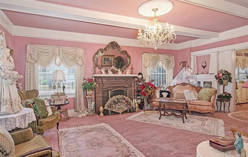outdated living room with pink walls, ceiling and pink carpet