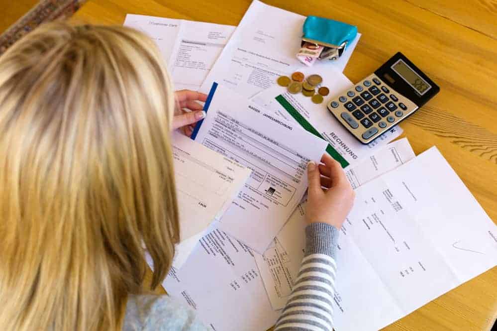 a woman with unpaid bills has many debts. unemployment and personal bankruptcy