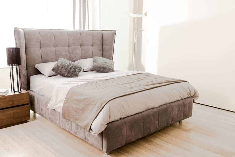 Any home refurb project comes with a multitude of questions. “What colour should the walls be?” “Are we REALLY putting that there?” “Isn’t that a bit expensive?” And so many more. When it comes to the bedroom, the questions are perhaps even more intense. The bedroom, after all, is a private haven of relaxation, a place you can feel snug and secure, a place where the kids run into on Christmas morning asking if “he’s been”.
So when it comes to decorating or altering it in any way, there will be plenty of decisions to work through. One that is normally high on the agenda is flooring. And with good reason. The floor is both the first thing your feet touch when you wake up and the last thing they touch before you get your head down. It’s also something that helps accentuate the style of your room and adds to the impression you want your room to create.
A thick fluffy carpet for example exudes warmth, coziness, and comfort. A wooden floor can create a rustic and vintage theme, whilst a vinyl-tiled floor could showcase style and modernity. Each works with the room’s furnishings and it can be very easy to inadvertently mix styles and create something that doesn’t work at all. Leaving you with a garish, uncomfortable, and odd-looking room
Below, we have picked a selection of the best bedroom flooring types you could invest in and what their pros and cons are. That way you can make an informed decision over the best flooring type for your bedroom.
First things to consider
Before we dive into the differing floor types that you could have laid, you should weigh up what you want your room to prioritise. Should it be style? Or should it be comfort? Could it be both?
Certain floor types will lend themselves to one more than the other, but it is possible to fuse the two a little.
It is also worth considering how you want the room to make you feel. This may sound odd but colour psychology - and yes, it is a thing - shows that the furnishings you use, and their colours, can play a large part in your mood! Red for example is meant to show love, energy, and strength, white can be cleanliness, simplicity, and honesty, whilst yellow can signify creativity, happiness, and warmth. Now for many, it may not mean anything, but research has shown that colours play a large part in our mood and as a result our interactions.
The bedroom flooring choices
Now you have weighed up whether it is a style or comfort vibe you are aiming for and have assessed the implications of the colour choices, it could be a good time to investigate the available options for bedroom flooring.
Carpet
Carpet is perhaps the first choice for many and that is understandable. It’s comfortable, it keeps the feet warm, and with the varying availability of colours, patterns and carpet types available, there are plenty of options to consider. Ordered to fit the size you need, it can be extremely cost-effective, and any waste can be used for garages, and other rooms or as spare parts for tears and other flooring damage.
If you have kids, carpet is also often preferred due to its cushioned surface. Factor in its sound dampening ability too and much of the noise that could come from any bedroom or even outside can be soaked up relatively well.
On the downside though, cleaning the carpet can prove to be tricky. Spillages can soak right into the carpet and leave unsightly stains as well as damage the fibres. When having new flooring laid, you want longevity, and carpet is perhaps one of the surface types where this isn’t guaranteed. Wear marks can appear in the most used areas, and this suddenly devalues the bedroom somewhat. In the same light, carpet just doesn’t have the same lifespan as hardwood or tile floor options. It should also be noted that some carpets contain chemicals in their manufacture, these can still be prevalent after they are laid. You should check with the carpet company before purchasing to see how your chosen carpet is made.
Hardwood bedroom flooring
Hardwood can make a bedroom look great. Especially if you are going for a more classical style. Hardwood can help a room make a statement. You can opt for solid hardwood, which is the variant made from thick planks of wood, or engineered hardwood, made from a veneer of real wood on top of a plywood core. Both hold a variety of benefits but also have a few negatives you may want to make note of.
Hardwood is durable and won’t show up the same wear and tear that a carpet might. This can stand to benefit you further down the line when it comes to selling your property as more of the value will be retained. Much like carpet, variety is there too. With a host of woods to choose from, you can find a finish that suits the rest of the house easily.
When complimented with a rug, the floor takes on even more character and should it be that you one day want to replace the hardwood floor, it's recyclable too!
On the downside though, there are definitely a few things to consider. Wood can be expensive and the type you choose can see prices change quite dramatically. Engineered hardwood will be cheaper but it is still likely to be more expensive than other types of flooring. Wood can also suffer from damage much more easily than other bedroom floor types. Regular coating can help but do you want that extra task? You will also find with hardwood floors that the absorption of sound and the heat insulation are minimal, meaning you may have to spend more elsewhere to help give your bedroom its desired results.
Obviously, and probably the most common thought regarding the negatives around hardwood is the injury risk. These surfaces do not offer much, if any shock absorption, so when you slip, trip, or fall, the impact could be hard and cause injury.
Vinyl tiling bedroom flooring
Vinyl tiling has long been a favourite flooring type for bathrooms and kitchens. Its waterproof nature and high level of durability lend itself well to high footfall areas, but what about in the bedroom?
Well, it's certainly possible and gives homeowners a fantastic form of flooring. With lots of design options available, a wood or stone effect is easily achieved at much less cost than if sourcing their natural equivalents. Add in the ease of keeping it maintained, the option for underfloor heating and its soft, comfortable feel and you have something that ticks many boxes. Whilst it may replicate hardwood or solid stone in the way it looks, the risk of falling and hurting yourself on an extremely solid surface is lost as the surface is much softer too. Such is the durability of these surfaces; you could see your flooring last 20 years or more before you even need to consider replacing it.
As with other flooring types, there are some negatives but with vinyl tiling, also known as LVT flooring, these tend to be outweighed by the positives.
The product isn’t recyclable like many other flooring types although Amtico, one of the market leaders in vinyl flooring has been undergoing a green revolution with work being carried out to ensure that all LVT products manufactured by them will include more recyclable materials.
Furthermore, and this isn’t always negative but may be perceived as one by some, the product often needs professional installation to ensure it is done just right.
Lastly, some property experts believe that this flooring type may not help maintain the house due to many prospective buyers seeing the product as a substitute for real wood or real stone.
Laminate flooring for the bedroom
Laminate flooring is another option popular with many. Simple to install, affordable and good to look at, it provides many with all the things they look for in a new floor type.
Made from a thin plastic laminate printed with a design, it is then bound to HDF and then coated with a protective coating.
With so many design choices available, it allows you to develop the room exactly in your vision and with stone, tile, and wood being replicated, it is easy to make it look much more expensive than it actually is.
Unfortunately, its ease of installation, affordability, and abundance of choice, leave it open to many negative attributes too.
Laminate scratches much easier than any of the other surface types we mentioned and can warp if it gets wet. In addition, it doesn’t provide much, if any, absorption against sound or offer much in terms of heat insulation either.
Unfortunately, should it get damaged, you may also find that repairs are quite difficult to complete. This often means having to replace entire sections which could then prove costly.
Ultimately, it comes down to you and what you want from your bedroom flooring. Hopefully the above has helped you find a flooring type that works for you, your style and your budget!
What Bedroom Flooring Should You Choose?