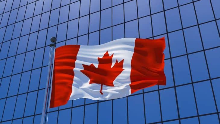 Canadian flag on skyscraper building background. 3d illustration Canada approvals, ISED certification for canada