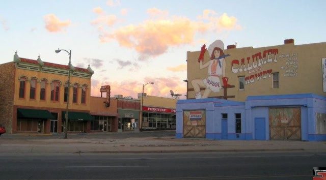 A historic building in Las Vegas, New Mexico, showcasing a vintage advertisement, highlighting the city's rich past and its connection to Route 66.