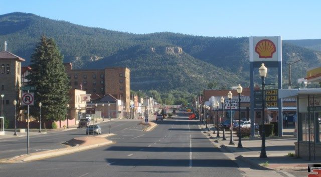 A view of First Street in Raton, New Mexico, with the Raton Pass and mountains in the background.