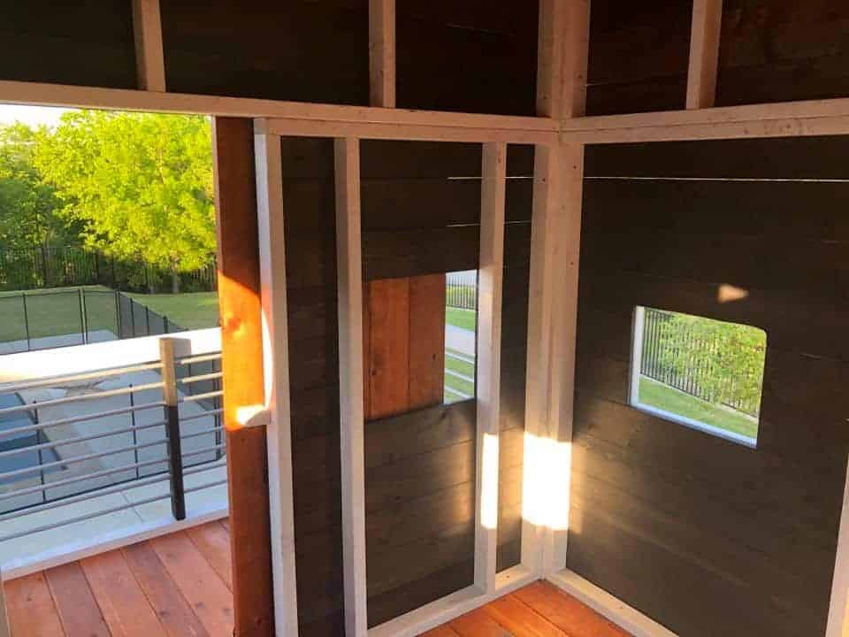 modern design swing set, new swing sets, interior cabin walls with ebony stain and white painted trim