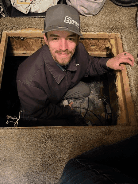 Barrier Pest Control team member performing access hatch inspection