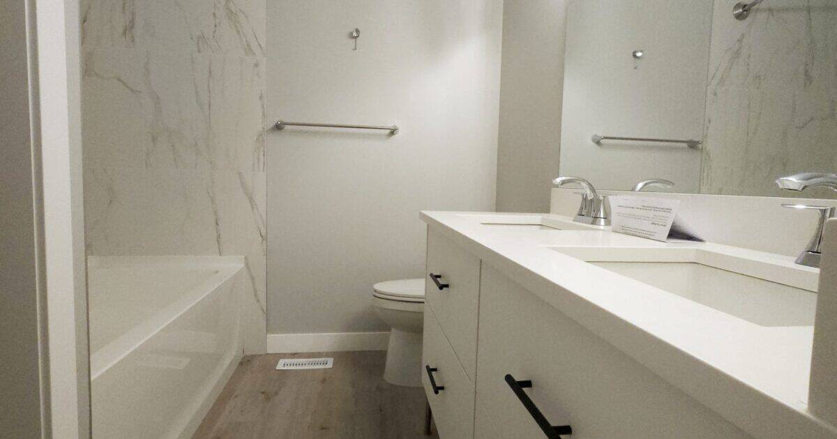 Remodelled bathroom with [walk-in glass shower, white subway tile, floating vanity] in Calgary