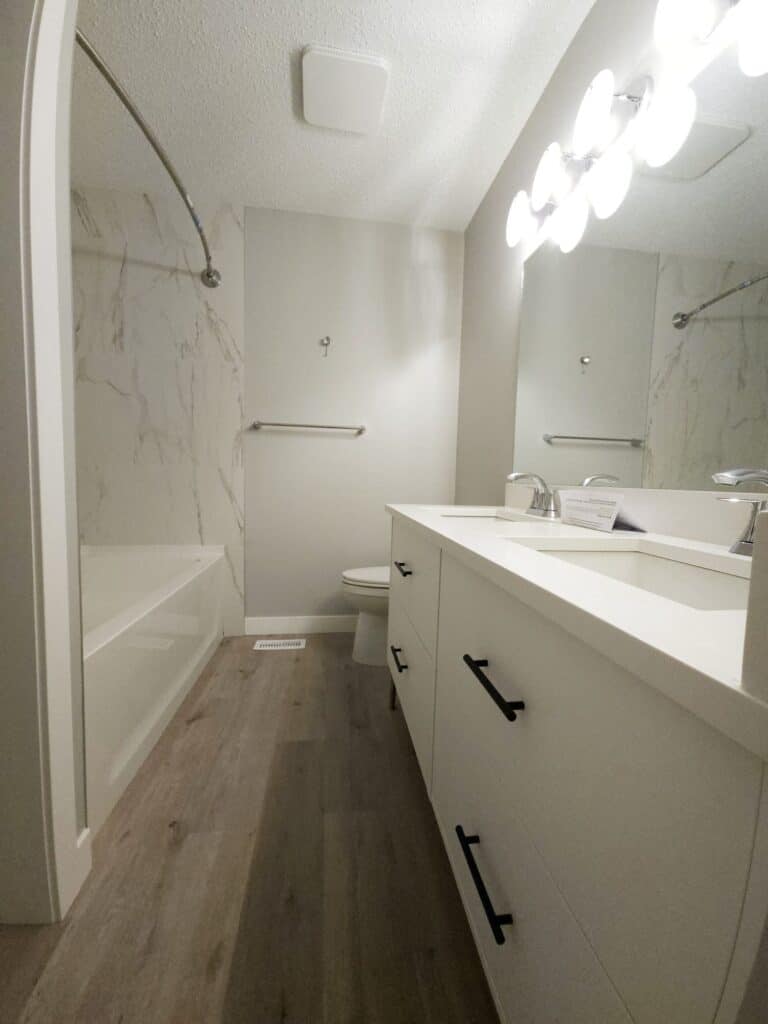 Remodelled bathroom with [walk-in glass shower, white subway tile, floating vanity] in Calgary