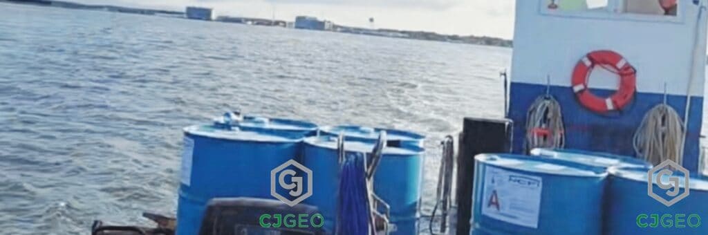 Logistics for a remote project: Grouting materials in blue drums transported by boat across the water to Tangier Island.