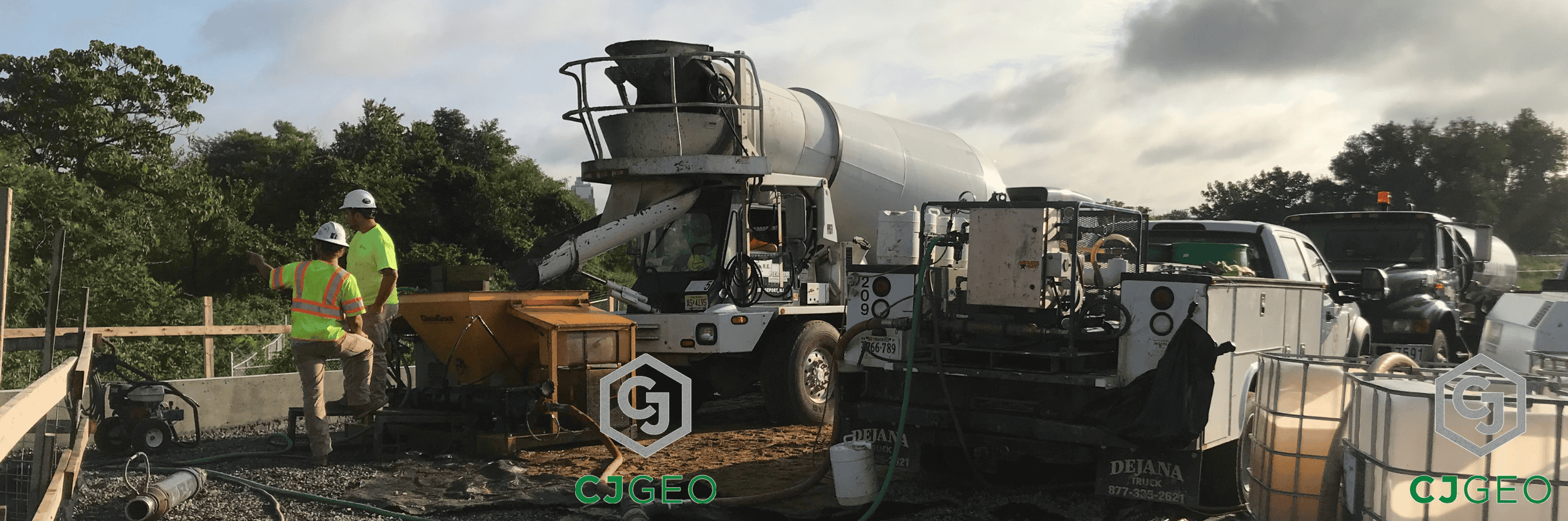 a front discharge ready mix truck discharging grout into a pump on a construction site