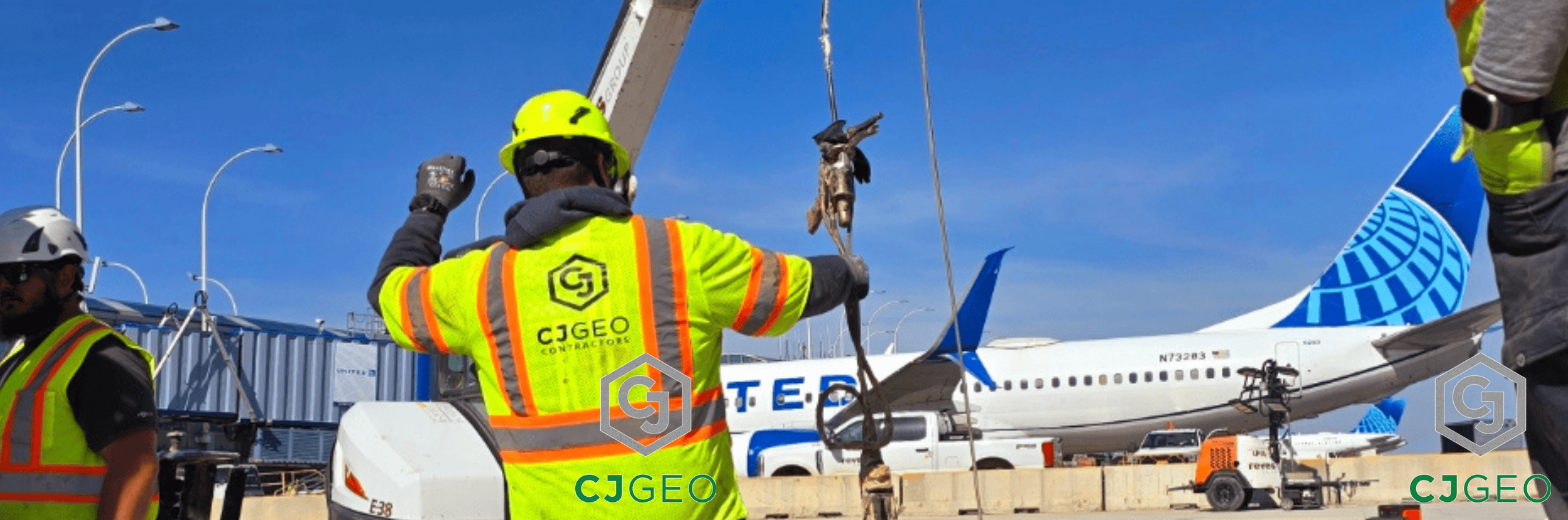 a CJGeo employee with a plane in the background at an airport construction project