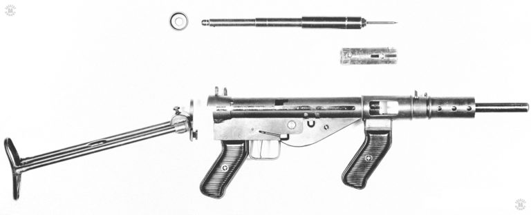 The Austen Mk I field stripped. At the top of the picture is the round end cap and the telescoping mainspring system. With the firing pin. This is almost a complete copy of the system as used in the German MP38 and 40 series of submachineguns. Though the folding stock is removable in the Austen and has a different locking system, it too is almost a complete copy from the German MP 38 and 40 designs. PHOTO CREDIT: US Army