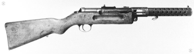 Right side close view of the MP18/I receiver with the bolt in the cocked (open) position. The cocking lever attached to the bolt is in the rear position, underneath the safety notch. It would need to be pulled slightly more to the rear and lifted to pu the weapon on safe. PHOTO CREDIT: US Army