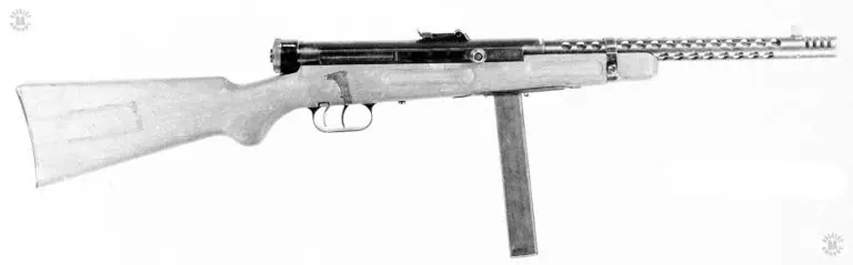 A right side view of the third variation of the Beretta 38A. This was an attempt to lighten the weapon due to feedback from Italian forces fighting in Africa. The bayonet mounting was removed and the compensator improved. The new model compensator consisted of four slots cut crosswise across and in front of the muzzle of the weapon. Materials and manufacturing techniques were also changed in this variation with the barrel jacket being formed of rolled steel, welded with the seam running along the bottom of the jacket. This variation also introduced the fixed firing pin to the series. This variation was produced for five years, running from 1939 to 1944. PHOTO CREDIT: US Army
