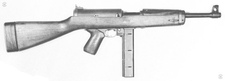The right side of the Hyde-Inland M2 submachinegun. A simple, straightforward design that was adopted by the US Military but was unable to get into production fast enough and was replaced by the M3 submachinegun. The weapon follows the lines of a standard carbine with a wooden stock and pistol grip. The thick receiver is due to the bolt having two diameters. The rear of the bolt is of a large diameter while the front portion is much smaller. This helps cut down the overall length of the weapon while still making it a simple blowback action. The Hyde-Inland M2 was designed to use the Thompson box magazines. This specimen is loaded with a 30 round magazine. PHOTO CREDIT: US Army