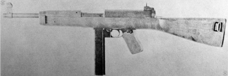 A fields-stripped view of the Hyde-Inland M2 submachinegun. The double-diameter of the receiver body can be clearly seen in this photo. This action is due to the unusual bolt, seen above the cocking lever (reversed) in the center of the picture. The thick, heavy body of the bolt allows the weapon to have a very short receiver. PHOTO CREDIT: US Army