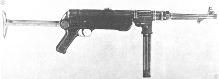 A right-side view of the MP38 with the stock extended and a magazine locked in place. The bolt is forward in the uncocked position where it can bee seen inside the ejection port. The reinforcing and lightening ribbing can be seen extending all the way around the upper receiver. PHOTO CREDIT US Army