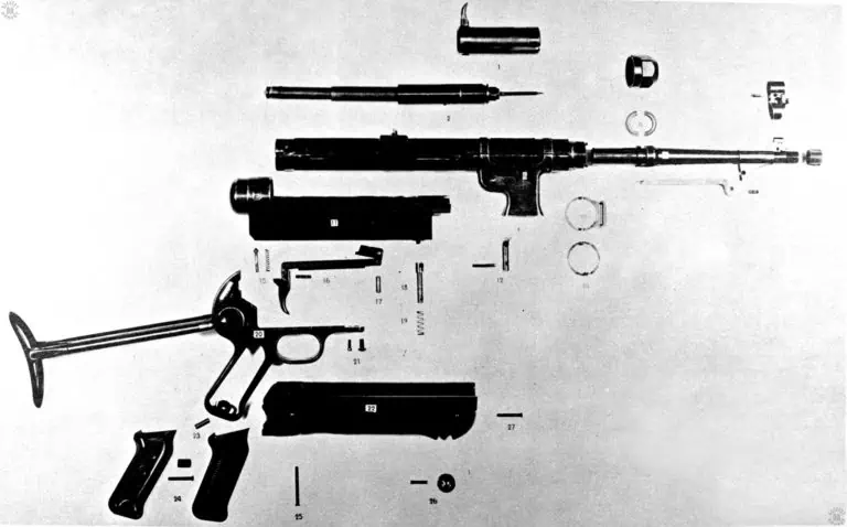 This is a completely disassembled view of an early model of the MP40 submachinegun. The only part missing in the picture is the magazine. The weapon is a relatively simple design with few parts, in spite of what is seen here. PHOTO CREDIT: US Army