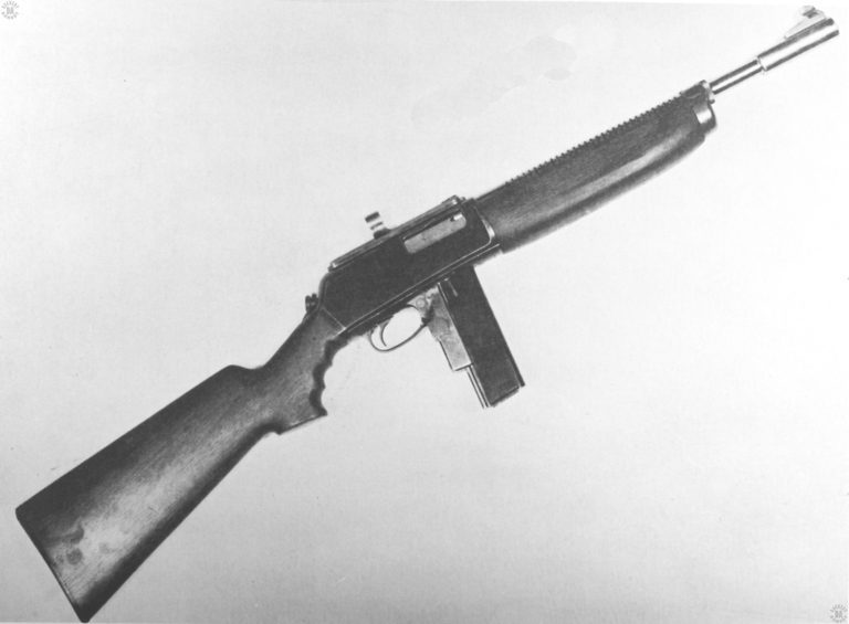 The right side of the Woodhull submachinegun. The resemblance to a carbine is due in no small part to the weapon being based on a Winchester self-loading rifle. The short, single column magazine holds 10 rounds and would be considered a handicap for a full automatic weapon. If the weapon had placed well in its trials, a larger capacity magazine would have been needed. The ring rear sight, at the top of the receiver, just to the rear of the ejection port, would have allowed for a very quick pickup of close in targets, making it a handy weapon for close-quarters combat. PHOTO CREDIT: US Army
