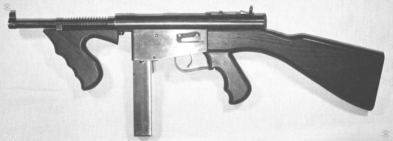 The left side of an Ingram Police model 6 submachinegun. The unique spring plate on the side of the trigger housing holds the pins to the trigger mechanism in place. PHOTO CREDIT: Kevin Dockery