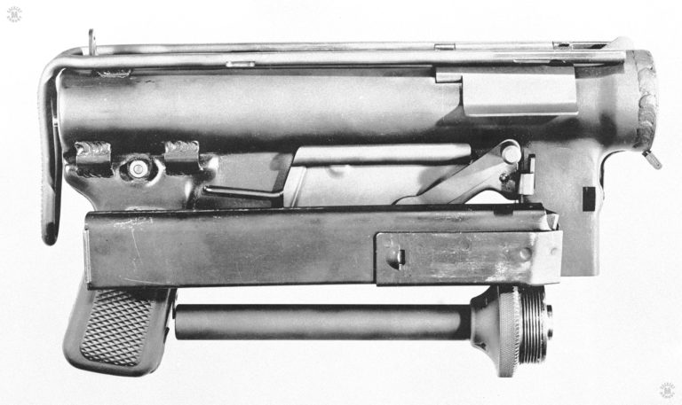 One of the suggested requirements for what became the M3 submachinegun was that it be able to be broken down into a compact package as practical for shipping or airdropping behind enemy lines. This is the weapon broken down to its components with a single magazine included. The stock is removed and lays across the top of the receiver. The barrel assembly is reversed and is underneath the receiver. On the top is a single 30 round magazine. Broken down in this manner, the M3 can fit in a box 32 cm (12.63 inches) long, 18.7 cm (7.38 inches) high, and 8 cm (3.13 inches) deep. PHOTO CREDIT: US Army