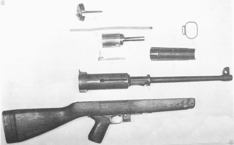 A fields-stripped view of the Hyde-Inland M2 submachinegun. The double-diameter of the receiver body can be clearly seen in this photo. This action is due to the unusual bolt, seen above the cocking lever (reversed) in the center of the picture. The thick, heavy body of the bolt allows the weapon to have a very short receiver. PHOTO CREDIT: US Army