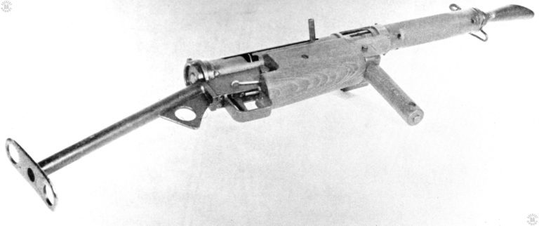 A bottom-rear view of the right side of the Sten Mk I. The cocking lever can be seen as a simple rod secured in the bolt. On the receiver, just above the front of the trigger group, is the safety notch on the bottom of the cocking handle slot. The Sten Mk I was the only weapon of the series to have the safety notch at the bottom rear of the cocking handle slot. PHOTO CREDIT: US ARMY