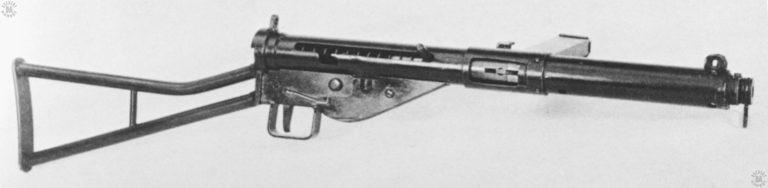 The Sten Mk I* conversion from the original weapon. The cone-portion of the flash suppressor has been removed from the weapon though the sling swivel mount was retained. The folding front grip and the wooden furniture have been removed completely. A sheet-match cover protects the trigger mechanism. The simple bolt handle is in the forward (fired) position. PHOTO CREDIT: US ARMY