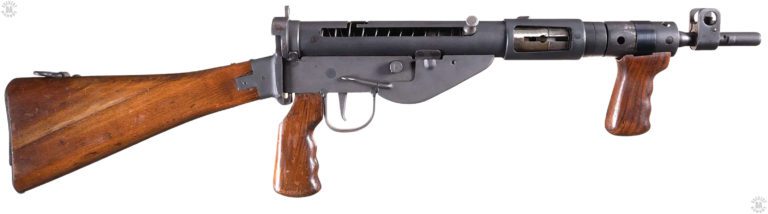 A near unissued condition Sten Mk V. The machining on the muzzle of the weapon is visible, the lugs allowing the attachment of the No 4 Spike bayonet from the No 4 Lee Enfield rifle. The vertical front grip is in place with the wear marks on the barrel nut showing how the handle could move during use. It was this movement that caused the handle to be ordered removed. The bolt is in the forward position with the Mk 5 safety cocking handle pressed in to lock the bolt in place. PHOTO CREDIT: ROCK ISLAND AUCTIONS