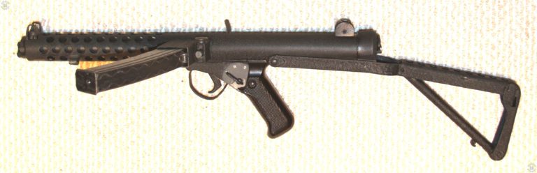 A left-side view of the L2A3 with the stock extended. The weapon is coated with a satin Sunkorite paint finish. The selector switch markings are A-R-S, for Automatic, Repetition (semiautomatic), and Safe. The selector lever has been pushed forward into the A position indicating that the weapon is set for full automatic fire. PHOTO CREDIT: KEVIN DOCKERY