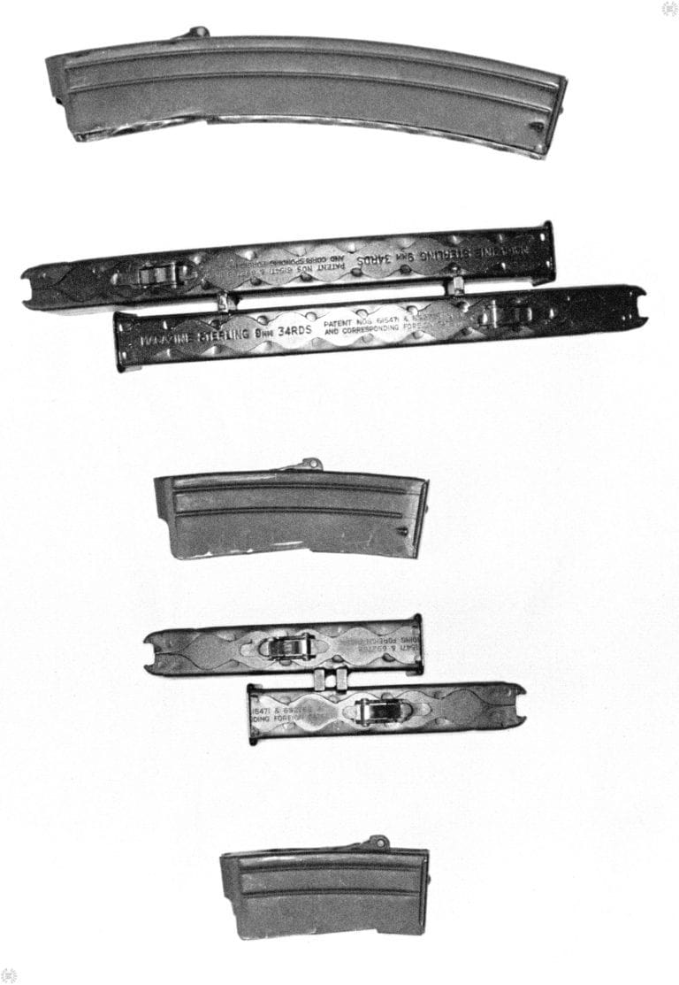 The assortment of magazine made for the Sterling submachine gun series. At the top is the standard 34-round Sterling magazine. The second magazines from the top are a pair of 34-round magazines factory made as a double-stack assembly. By simply pulling the magazine out of the receiver, flipping the assembly over, and reinserting into the gun, the weapon can be very quickly reloaded. Because the magazines are held horizontally in the weapon, there is less chance of foreign matter or debris entering the mouth of the top magazine and possibly causing a jam.
     The center magazine is a 15-round single magazine. Below the 15-round magazine is a double-stack pair of 15 round mags. The magazine at the bottom is the 10-round version. This magazine is too short to be practically made into a double-stack variation. PHOTO CREDIT: KEVIN DOCKERY