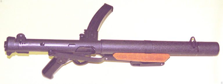 The Sterling Mk 5 submachine gun with the stock in the folded position. The bolt has been cocked to the firing position on this specimen and a 34-round magazine locked into place. PHOTO CREDIT: KEVIN DOCKERY