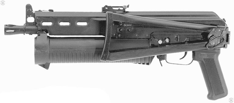 A left-side view of the Bizon with the stock folded to the side. Between the struts of the stock can be seen the dove-tail side rail riveted to the side of the receiver. This rail is used with many Russian optical and electro-optical sights. The single sling swivel at the rear of the folded stock allows for a simple loop to be used as a sling. The loop would be slung over a shoulder and the weapon carried muzzle-down, concealed under a coat or jacket. PHOTO CREDIT: RUSSIAN FEDERATION