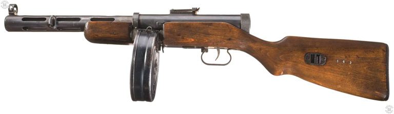 A left-side view of the PPD-40. This specimen shows the smoothly machined receiver, one of the points against the rapid production of the weapon. The major change in the PPD-40 from that of the earlier designs in the series is the use of the 71-round drum with the fitting of the drum being deep inside the receiver. The support to the drum from the front and rear sides of the magazine well help keep it from moving under recoil. The inertia of a drum full of ammunition can force an unsecured magazine from the weapon when it is fired. The loop of the top side of the drum is for a lanyard to help carry it as a spare magazine. PHOTO CREDIT: ROCK ISLAND AUCTIONS
