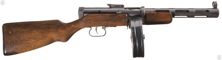 The right-side of the PPD-40. The locking slide on the cocking handle can be seen to the top of the handle, just behind and below the ejection port. The bolt can be locked in the forward position, or the bolt drawn back and the lock slid into the rear notch, seen above and in front of the trigger, up on the side of the receiver. In front of the trigger is the selector switch. The number “71” can be read, indicating that the firing selector has been set for full automatic. PHOTO CREDIT: ROCK ISLAND AUCTIONS