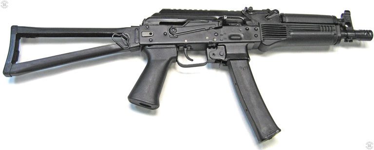 Right side view of the Vityaz-SN with the folding stock extended. The top cover is hinged at the front end which allows the Picatinny rail to be used with accuracy when mounted with an optical or electro-optical sight. This specimen is loaded with a single 30-round magazine that does not have the second-magazine attaching hardware. The Safety/selector switch is all the way up in the Safe position where it also locks the bolt in the forward position. PHOTO CREDIT: RUSSIAN FEDERATION