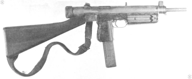 The Czech Model Vz-24 with the fixed stock. This specimen has the smaller mounting block for the rear sight and shoulder stock welded to the receiver rather than attached to a machined part as in the earlier weapons. The distinctive tilting pistol grip and magazine well are obvious in this view. The body of the 7.62mm magazine has a wide longitudinal groove pressed into the body of the magazine to aid in identification. The magazine filler tool specific to the Czech Vz 23, 24, 25, & 26 submachine gun series in position on the right side of the fore end. PHOTO CREDIT: US ARMY