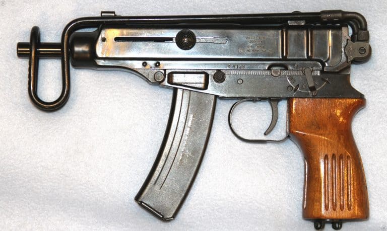 A left-side view of the Vz-61 Skorpion. The bolt is locked back on an empty 20-round magazine in this picture, indicated by the position of the cocking knob being held back in its slot. Above the pistol grip is the safety/selector switch. The switch is pointing down to the “0” position, indicating that the weapon is set on safe. Pushing the switch forward with the thumb of the firing hand puts it on the “20” notch, setting the weapon to full automatic fire. The rearmost notch, marked with a “1”, is the setting for semiautomatic fire. PHOTO CREDIT: KEVIN DOCKERY