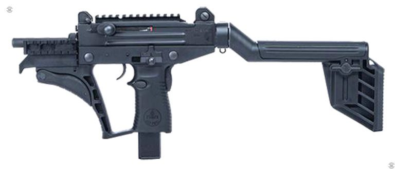 The left side of an Uzi PRO submachine gun with the stock extended. This specimen is fitted with the standard length 17 cm (6.7 in) barrel which is partially obscured by a section of MIL-STD-1913 “Picatinny” rail attached to the front of the weapon. The front assault grip is folded up against the front of the enlarged trigger guard. The cocking knob is at the side of the receiver, just below the top of the weapon. Directly above the pistol grip is the safety/selector switch in the rearmost, Safe, position. Below and behind the trigger itself is the push button for the magazine catch. At the rear of the pistol grip, on the opposite side from the trigger, is the grip safety.  The stock is locked in the open, extended position with the adjustable cheek piece in the lowered position. The T-shaped piece at the top center of the butt piece is the lock for the cheek rest. PHOTO CREDIT: IWI